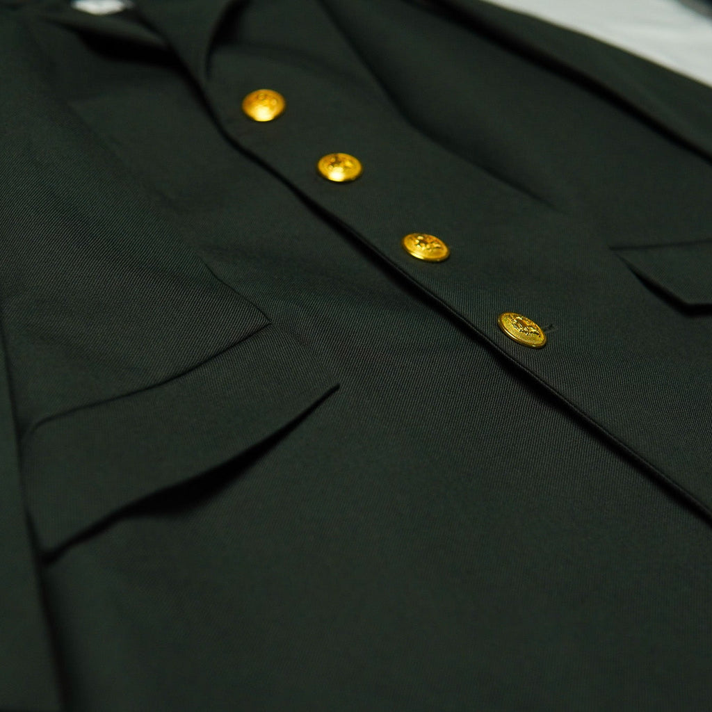 Close-up of a dark green uniform with gold buttons