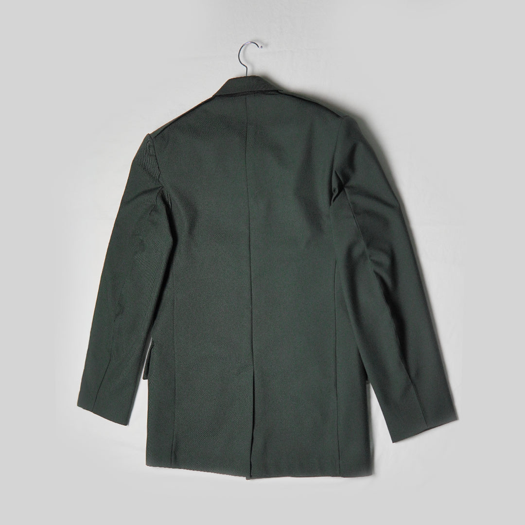 Green coat on a hanger against a light gray background