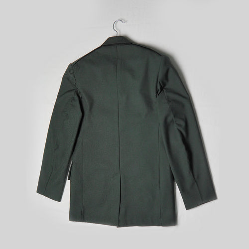 Green coat on a hanger against a light gray background